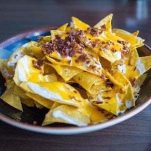 Tortilla Chips with Creamy Nacho Cheese & Bacon Crunch Topping
