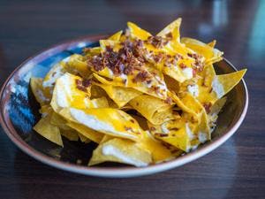 Tortilla Chips with Creamy Nacho Cheese & Bacon Crunch Topping